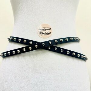 Black studded faux leather belt with silver accents